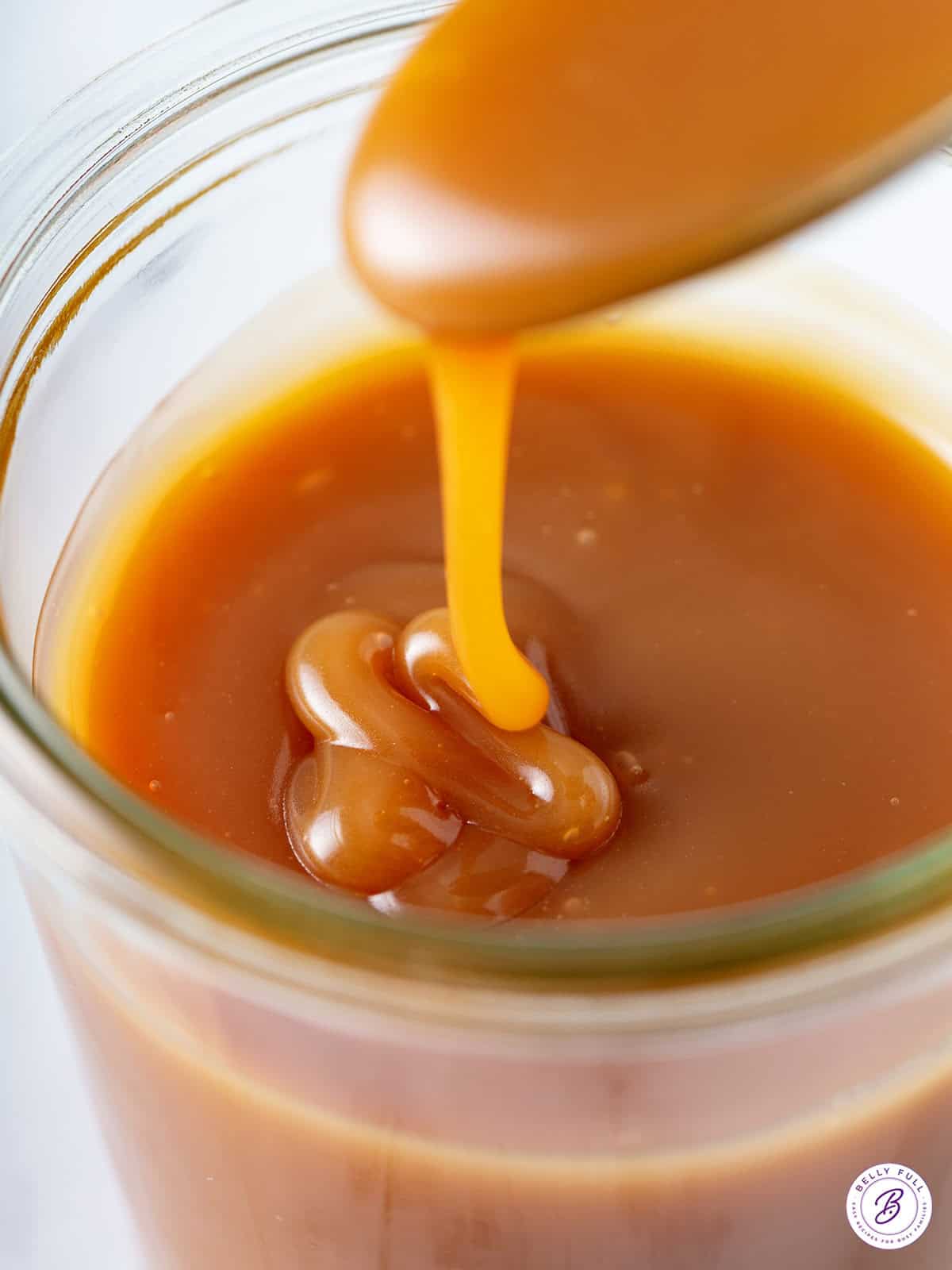 close up gooey caramel sauce on spoon