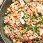 A green bowl of crispy rice salad