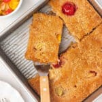 A slice of cuppa cuppa cake on a spatula in the pan