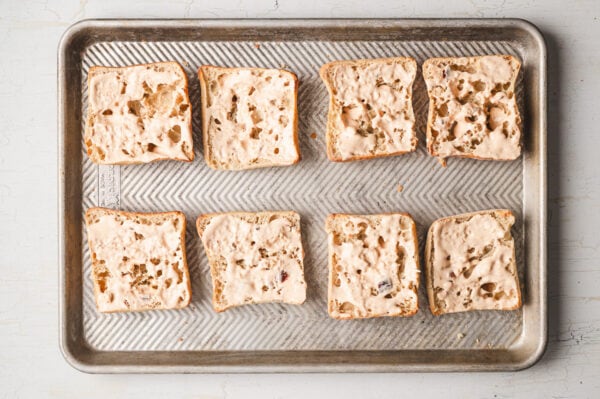 Toasted ciabatta rolls on a baking sheet
