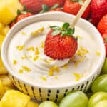 Dipping a strawberry in lemonade fruit dip