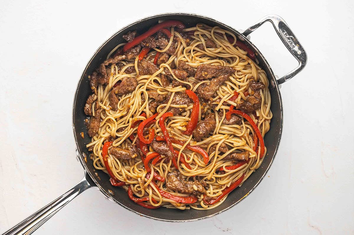 Overhead view of a skillet of Mongolian beef noodles