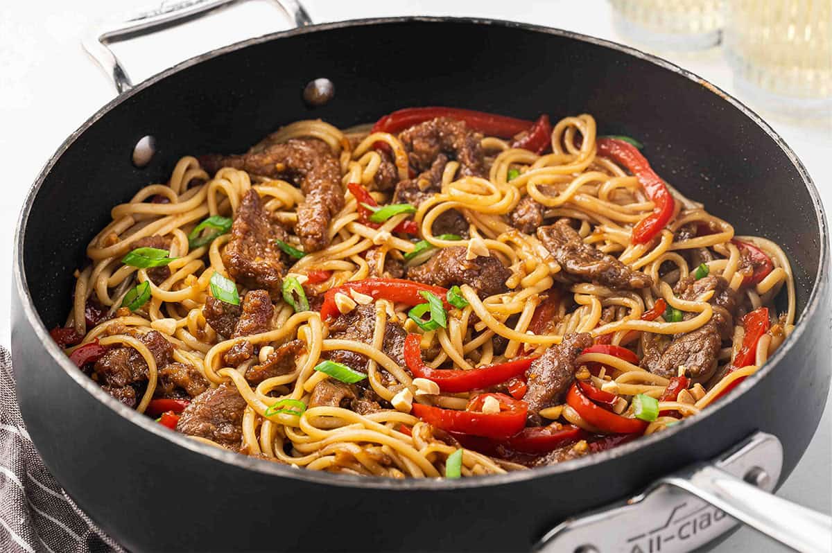 Side view of a skillet of Mongolian beef noodles