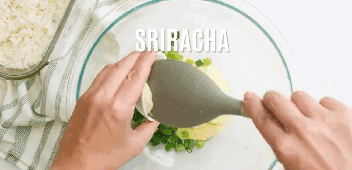 Combining the ingredients to make the crab mixture.