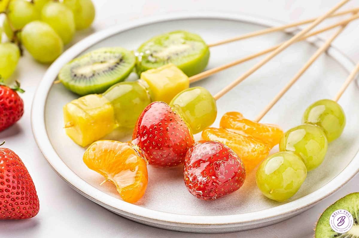 Tanghulu is made with skewers of fresh fruit dipped in a hard sugar coating. Made with just 3 ingredients, it's so simple and easy to make! A plate of tanghulu