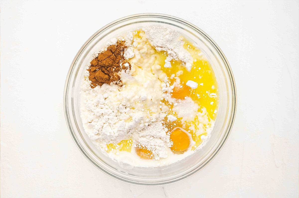 Cake mix, eggs, spices, and milk in a bowl
