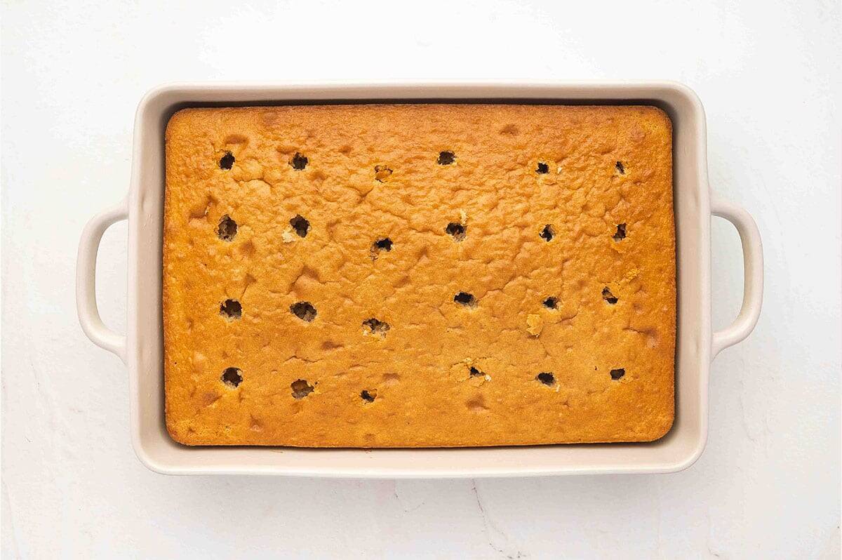 Overhead view of a cake with holes poked in it