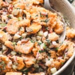 A spoon in a bowl of dill pickle tater tot salad