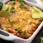 uncut Mexican Lasagna in white baking dish