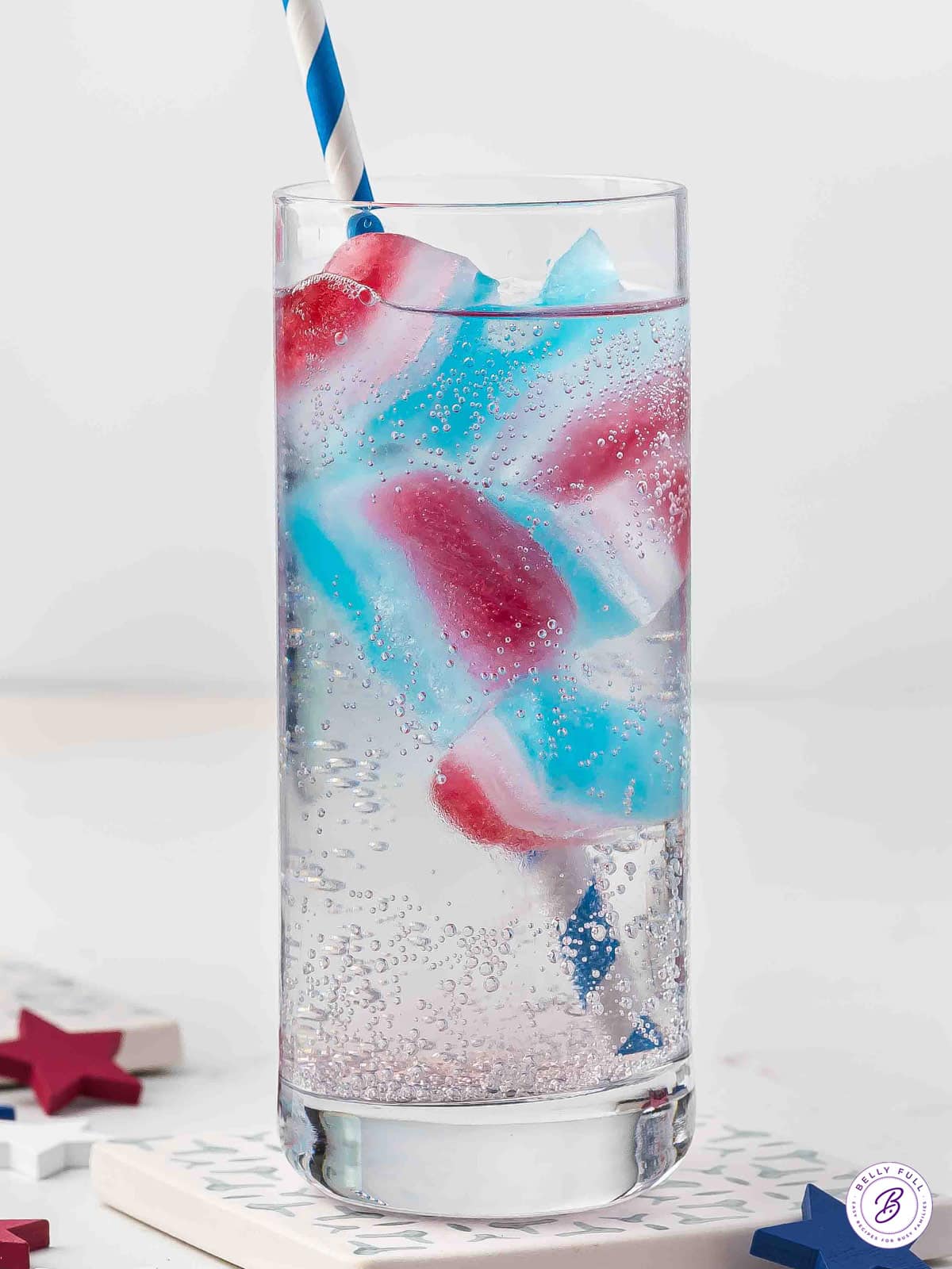 red white and blue flavored ice cubes in drink with straw
