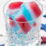 red white and blue layered ice cubes in glass