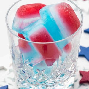 red white and blue layered ice cubes in glass
