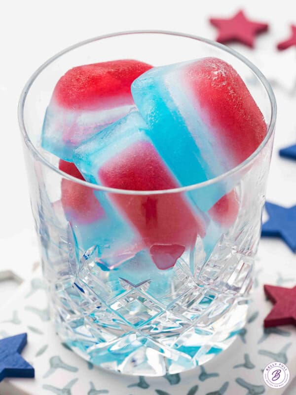 red white and blue layered ice cubes in glass