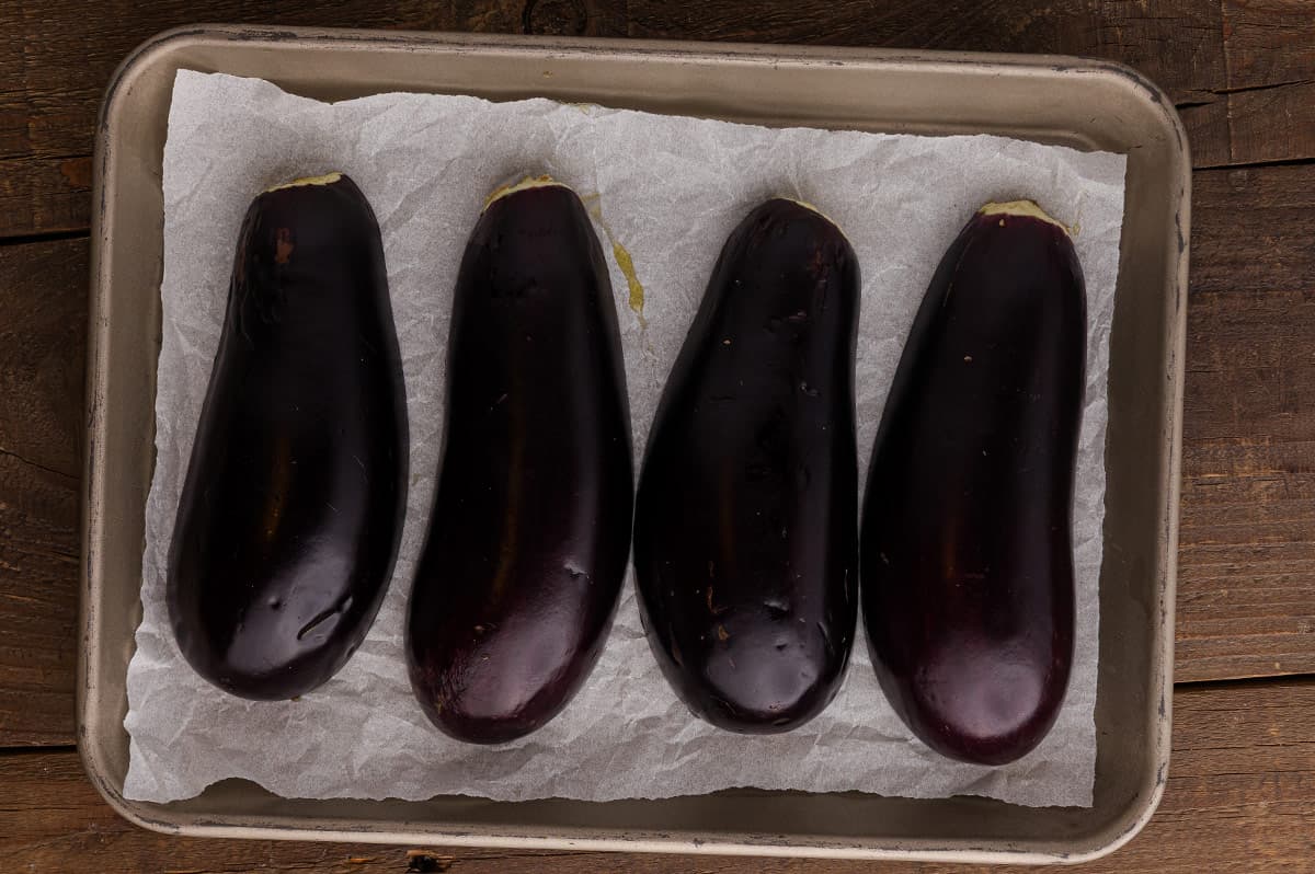 Eggplant halves roasted with golden brown edges and softened flesh.
