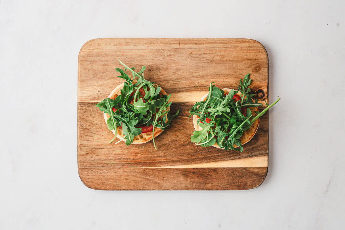 A spatula lifting a finished frico egg from the skillet, showcasing the golden, lacy cheese crust.