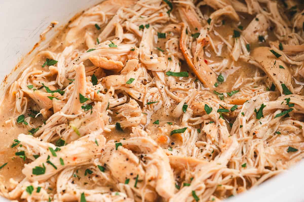 Creamy mashed potatoes topped with shredded 3-packet chicken and gravy, served with green beans.