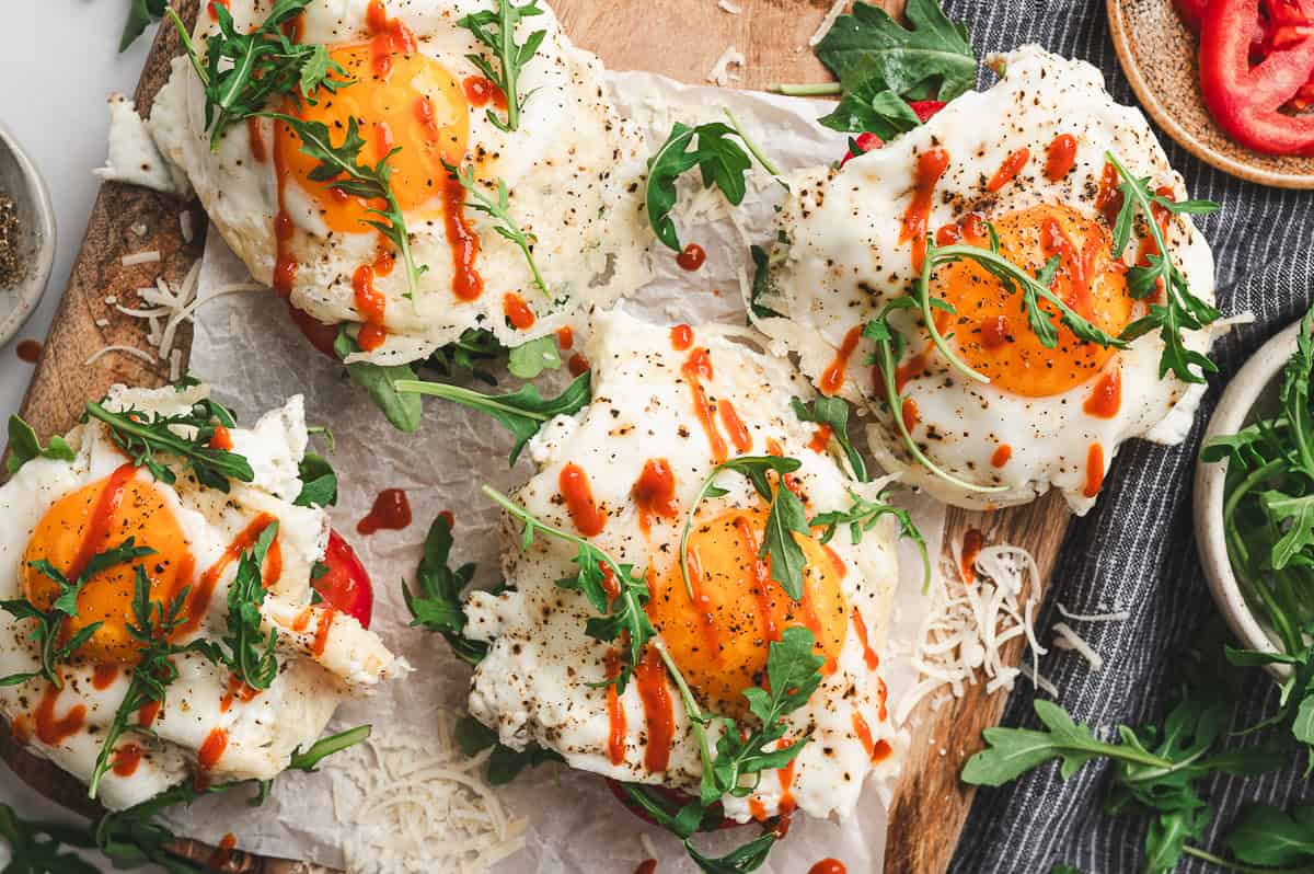 A bite taken from a frico egg, showing the runny yolk and crisp cheese edges.