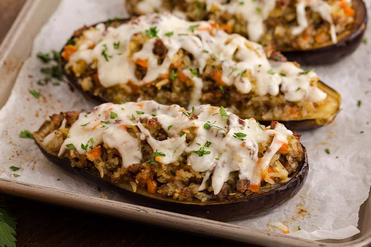 Stuffed eggplant halves baked and golden, just out of the oven.