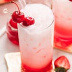 Overhead view of an Italian soda with maraschino cherries