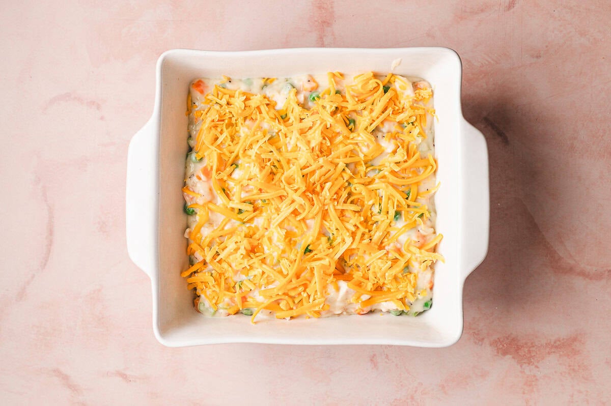 he creamy chicken filling spread evenly into a white baking dish, ready for topping.