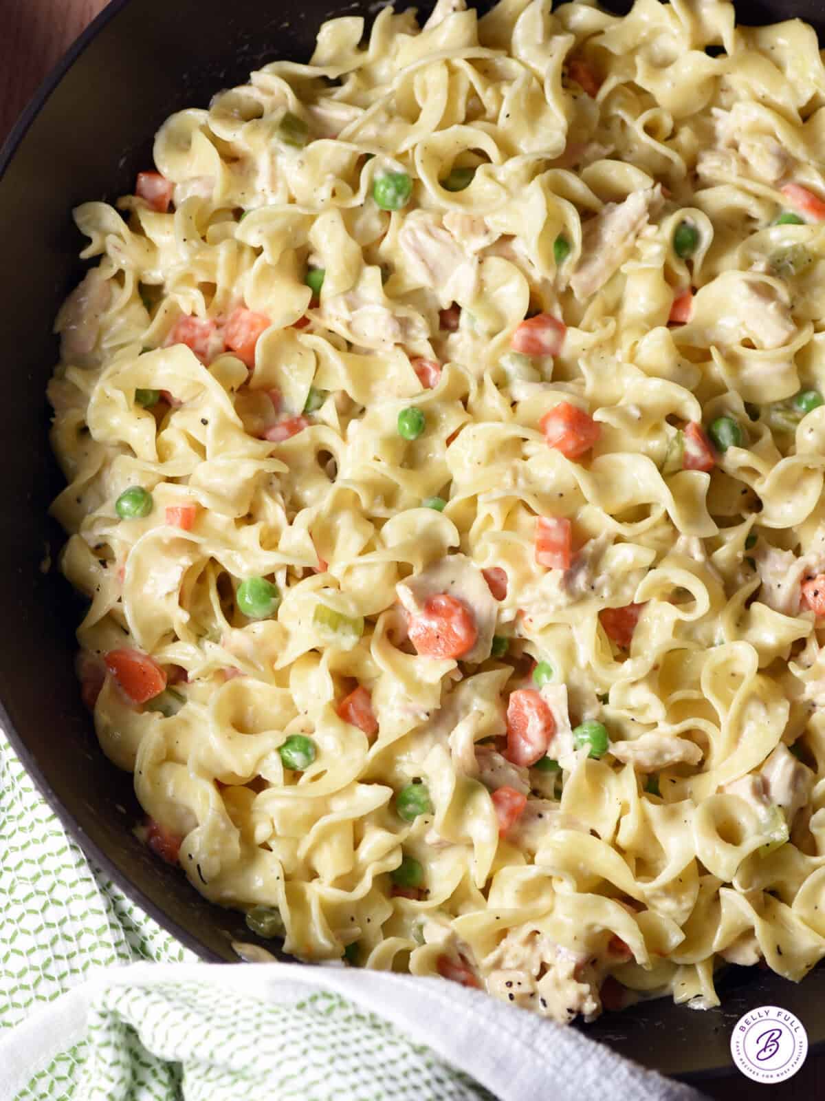 overhead skillet with egg noodles, chopped chicken, peas & carrots, in a creamy sauce