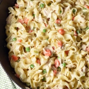 overhead skillet with egg noodles, chopped chicken, peas & carrots, in a creamy sauce