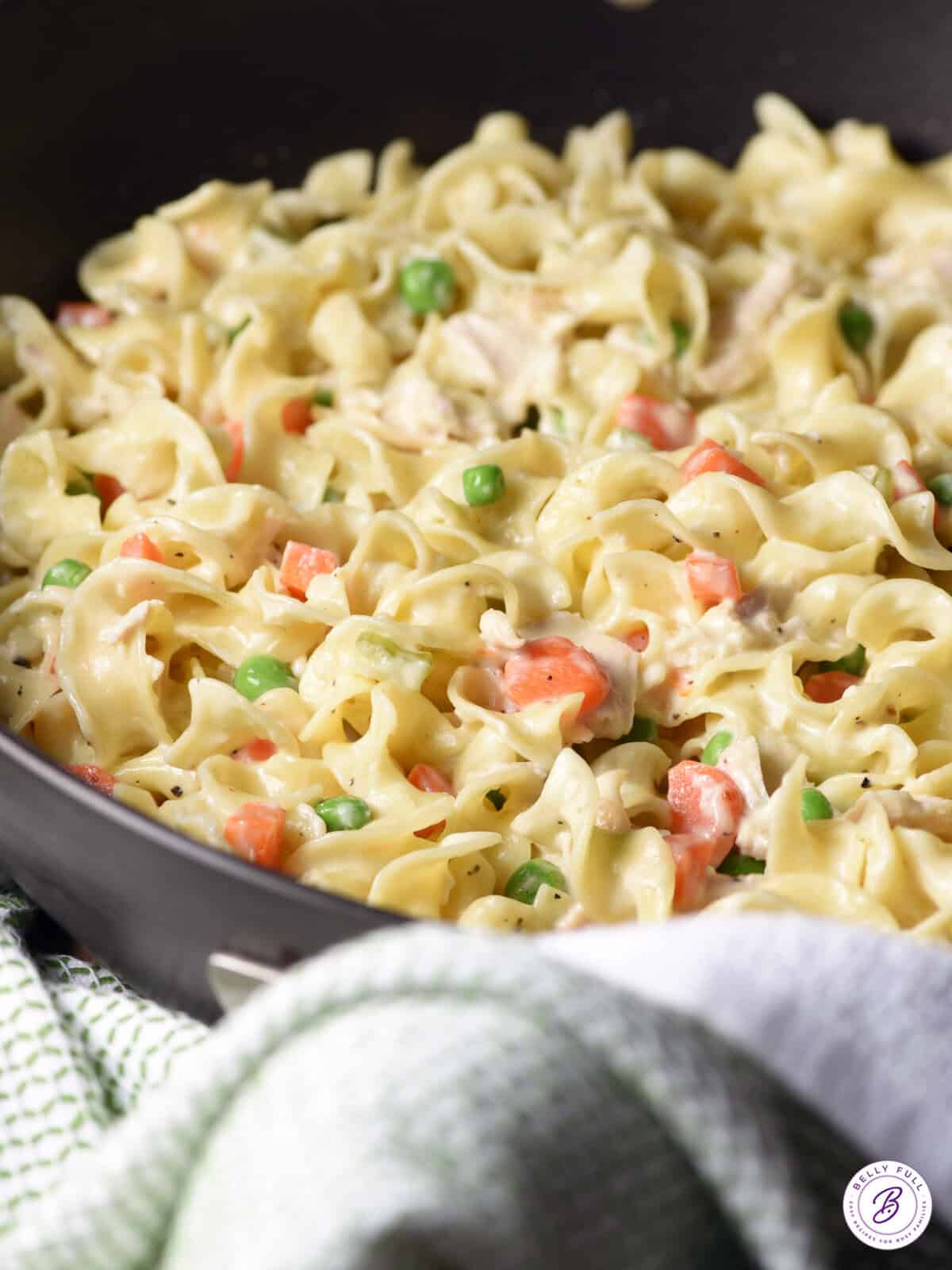 skillet with egg noodles, chopped chicken, peas & carrots, in a creamy sauce