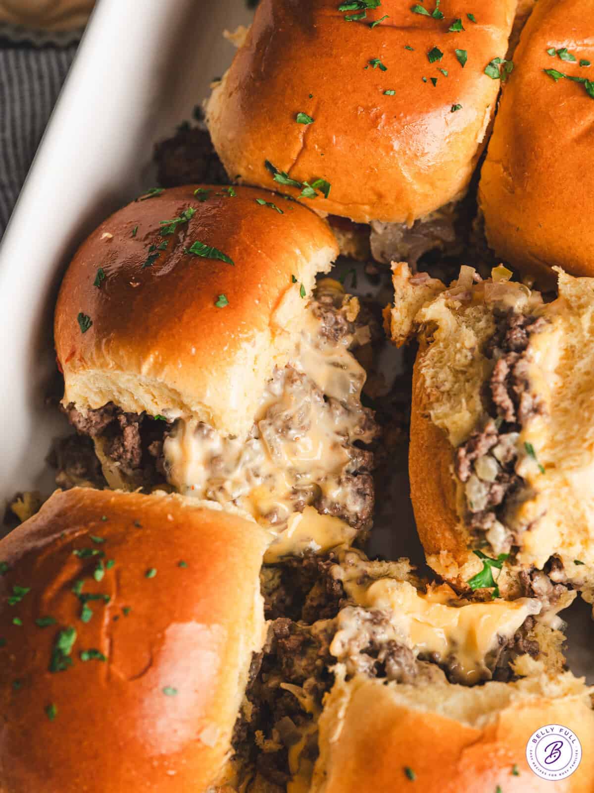 close up baked chopped cheeseburger sliders