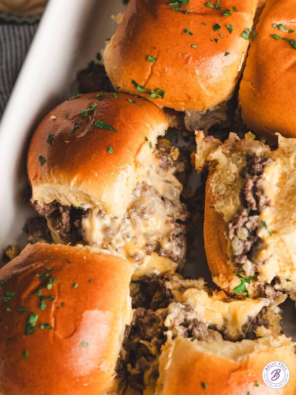 close up baked chopped cheeseburger sliders