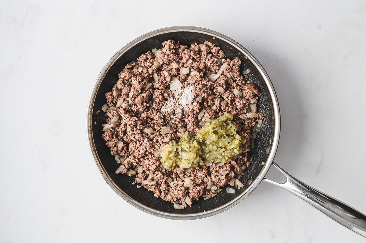 cooked ground beef, onion, pickle relish, and seasonings in skillet