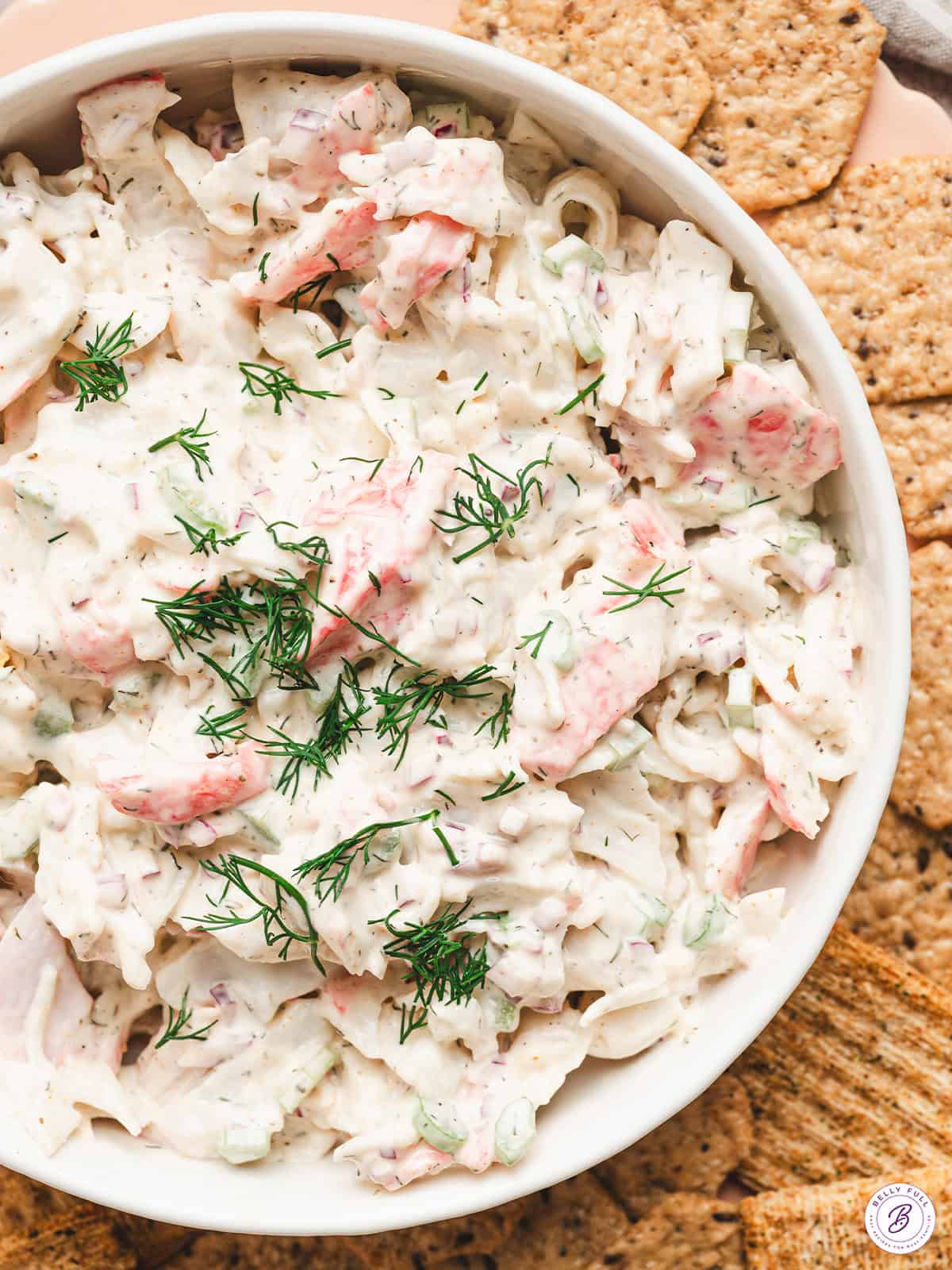 overhead dish of crab salad garnished with fresh chopped dill