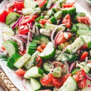 Cucumber Tomato Salad with dill and avocado on serving plate