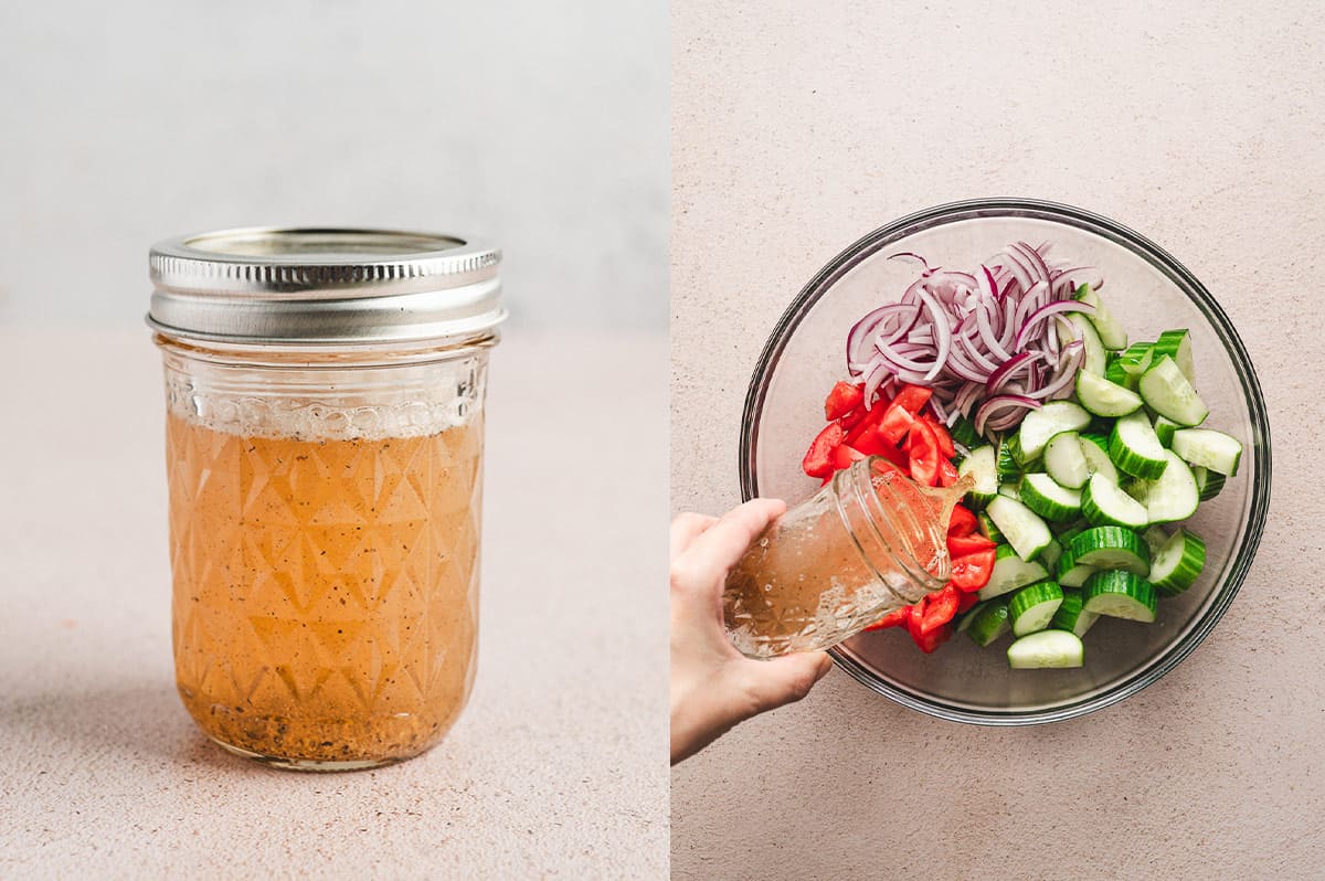 jar of vinaigrette being poured over diced cucumbers, tomatoes, and red onion in glass mixing bowl