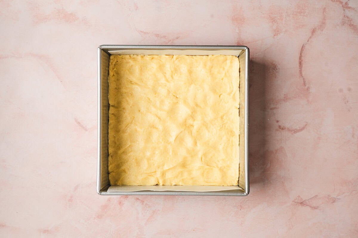 dough pressed into the bottom of a 9x9 square pan