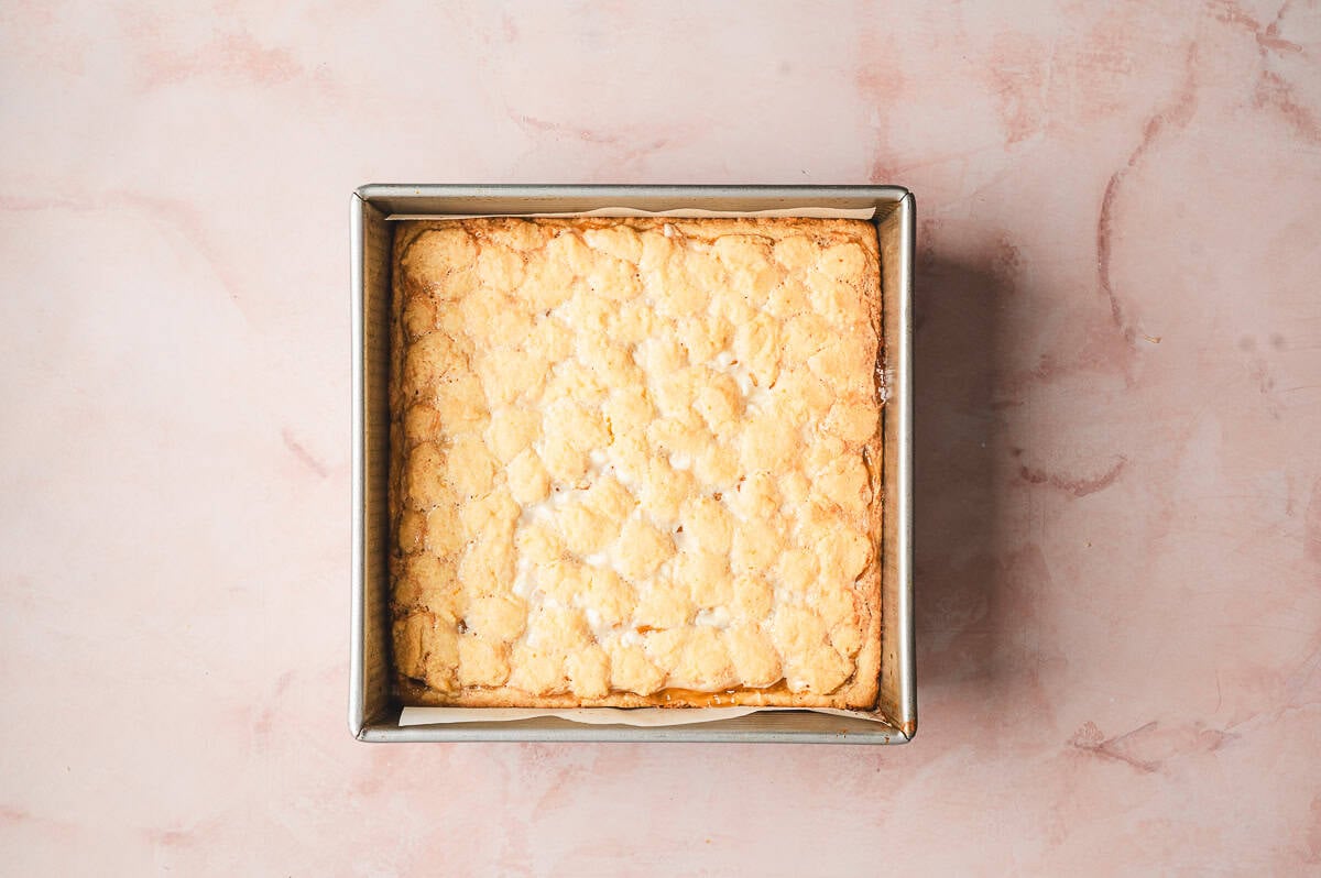 uncut baked lemon gooey bars in square baking dish