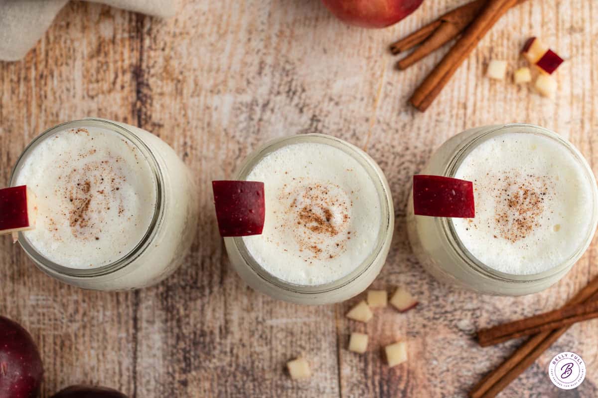overhead 3 mason jars filled with apple pie smoothie