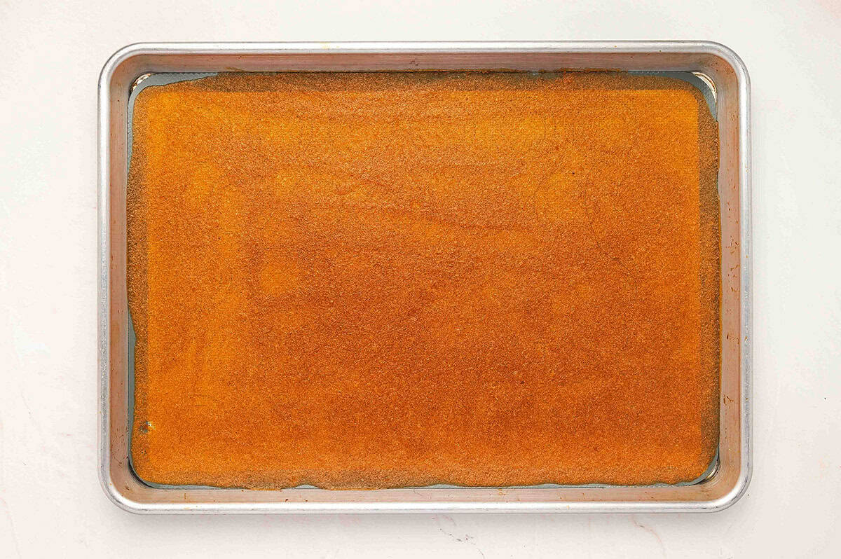 Fully baked apple fruit leather sheet on a baking tray, evenly dried and set.