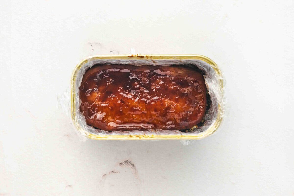 Glazed Spam slice layered on top of rice and furikake in Spam can mold