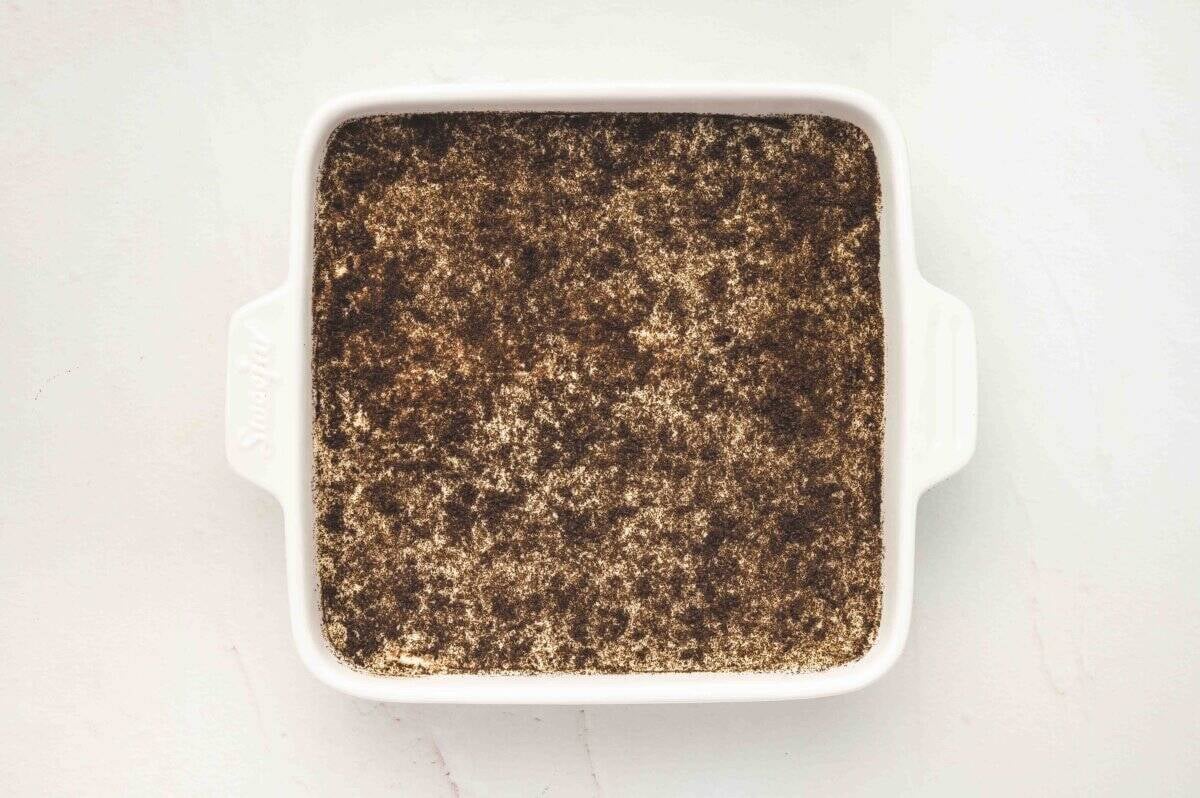 The finished Oreo tiramisu in the baking dish, topped with a generous layer of finely crushed Oreo crumbs.