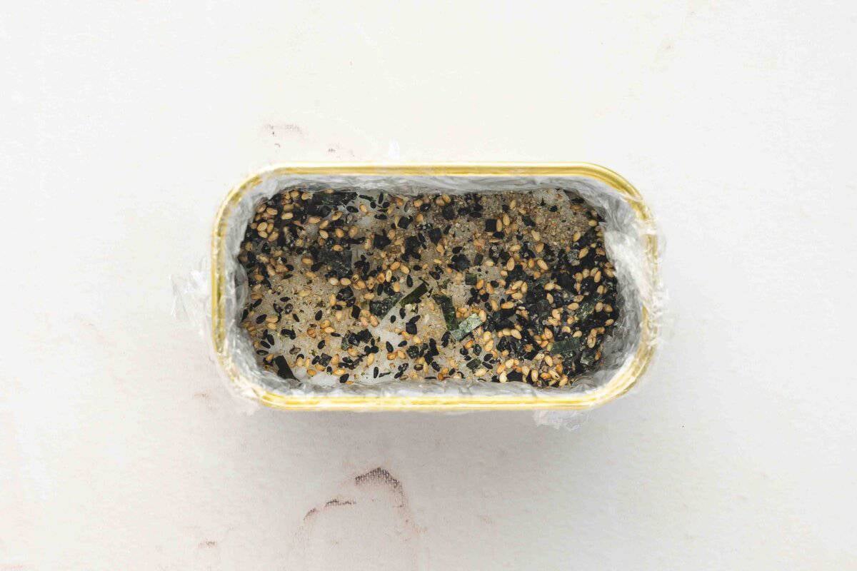 Pressed sushi rice in Spam can sprinkled with furikake seasoning