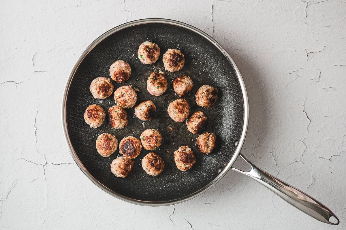 homemade Italian Meatballs being browned in fry pan