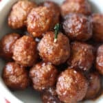 slow cooker cranberry meatballs in bowl with toothpick