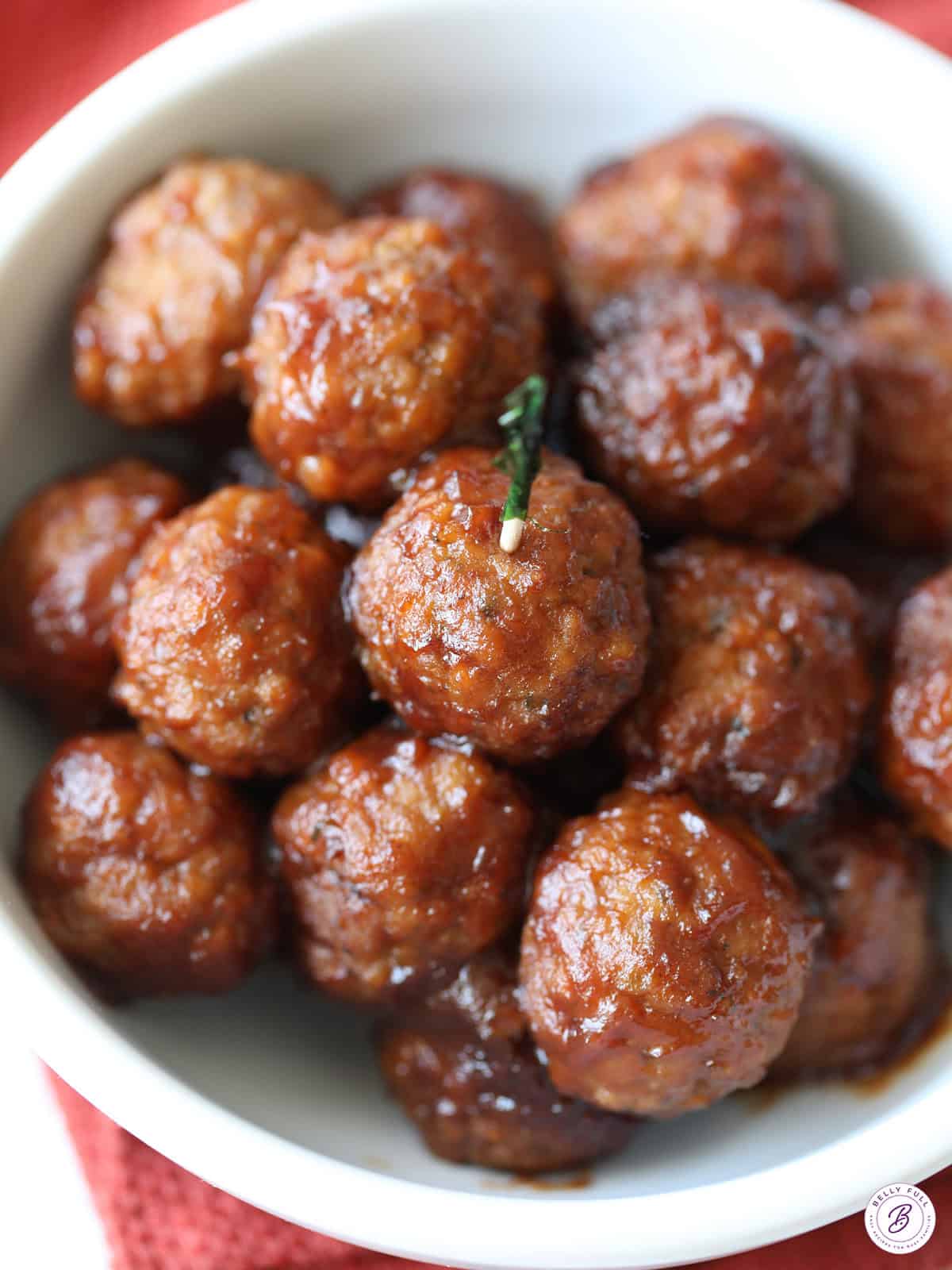 slow cooker cranberry meatballs in bowl with toothpick