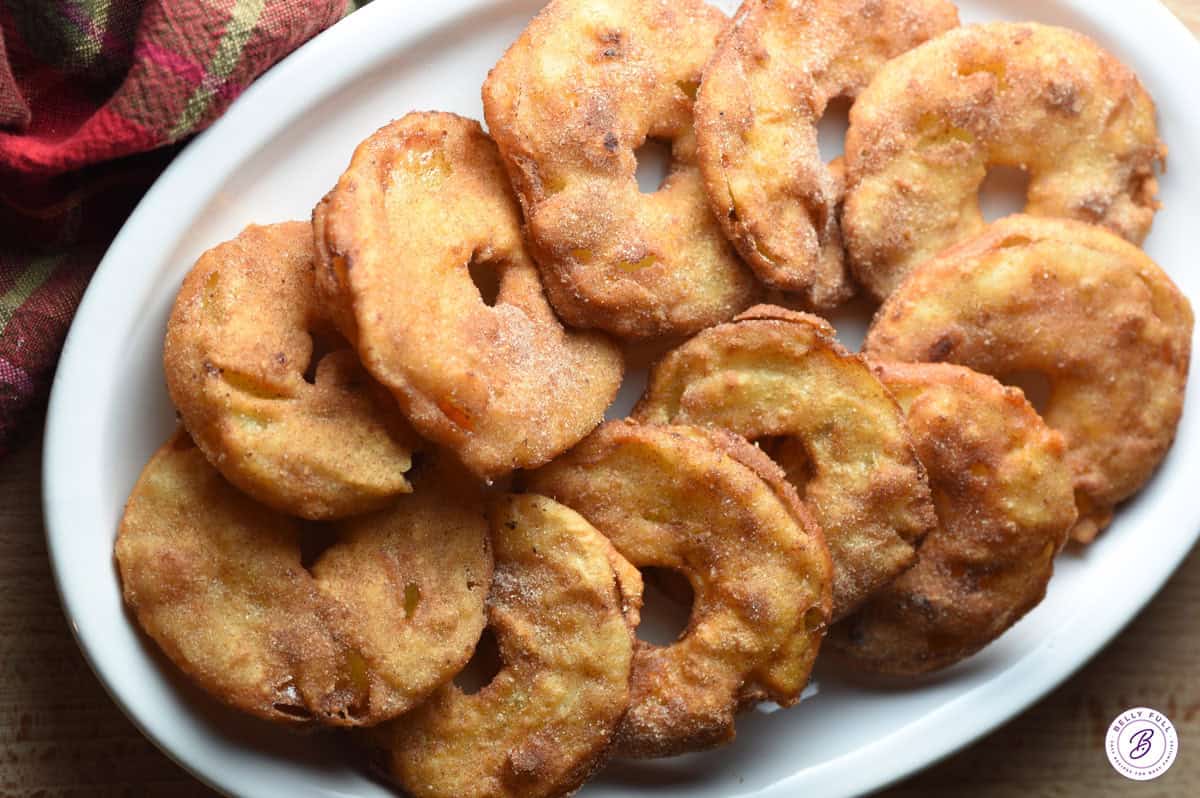 apple fritter rings overlapped on serving platter