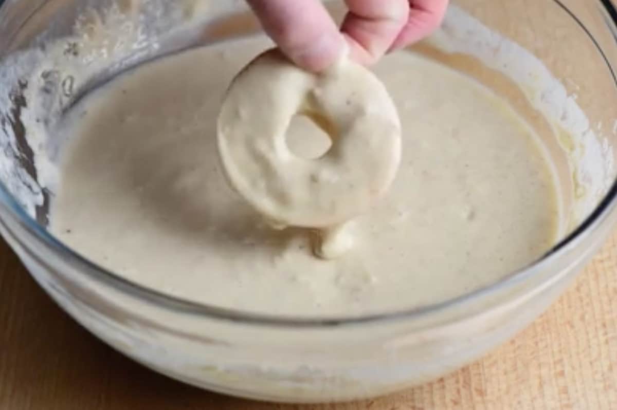 Sliced apple being dunked in batter