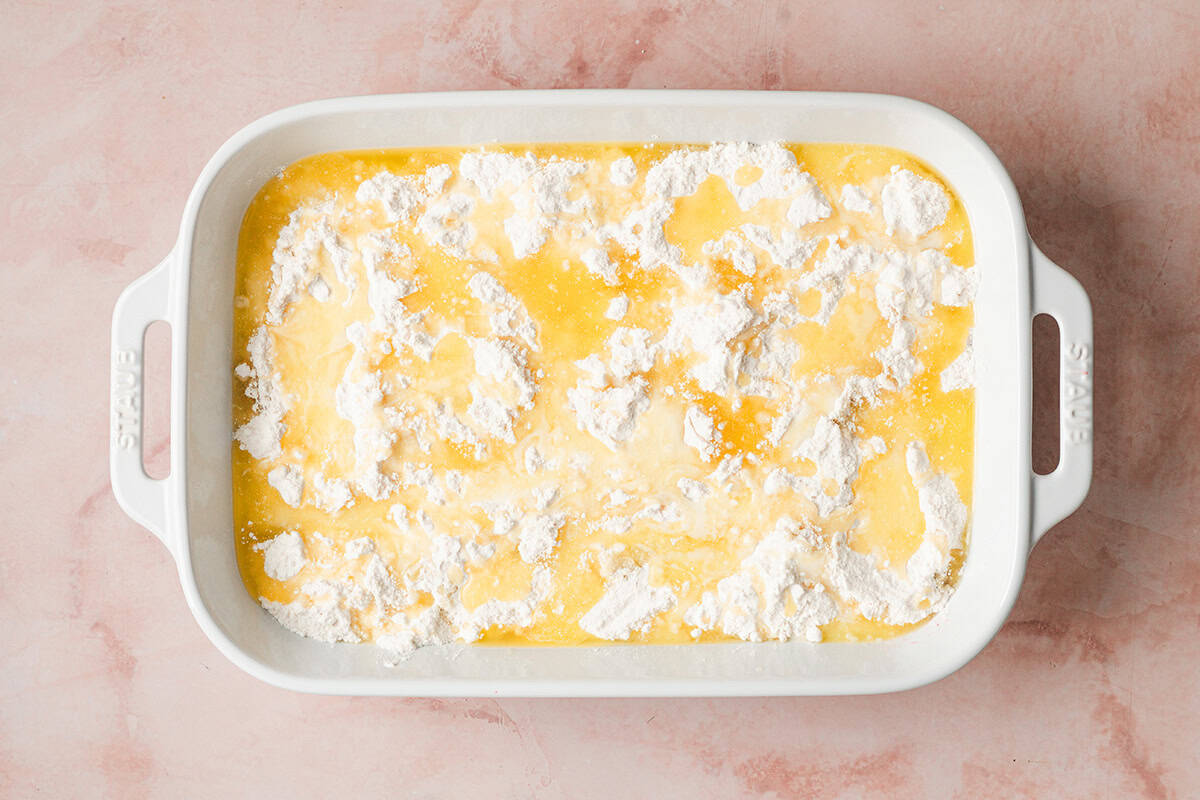 melted butter drizzled over yellow cake mix in casserole dish