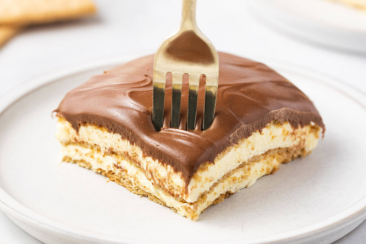 Fork in slice of No-Bake Chocolate Eclair Cake