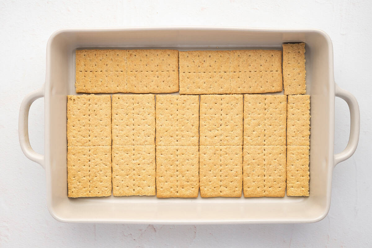 A layer of graham crackers in casserole dish