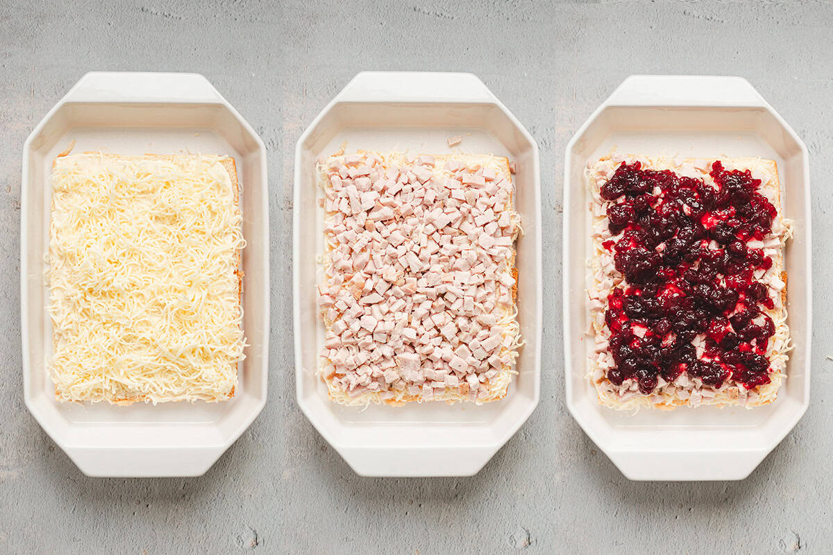 Side by side images: Left: bottom rolls topped with shredded Monterey Jack cheese. Center: diced cooked turkey layered over cheese. Right: cranberry sauce spread evenly over turkey.