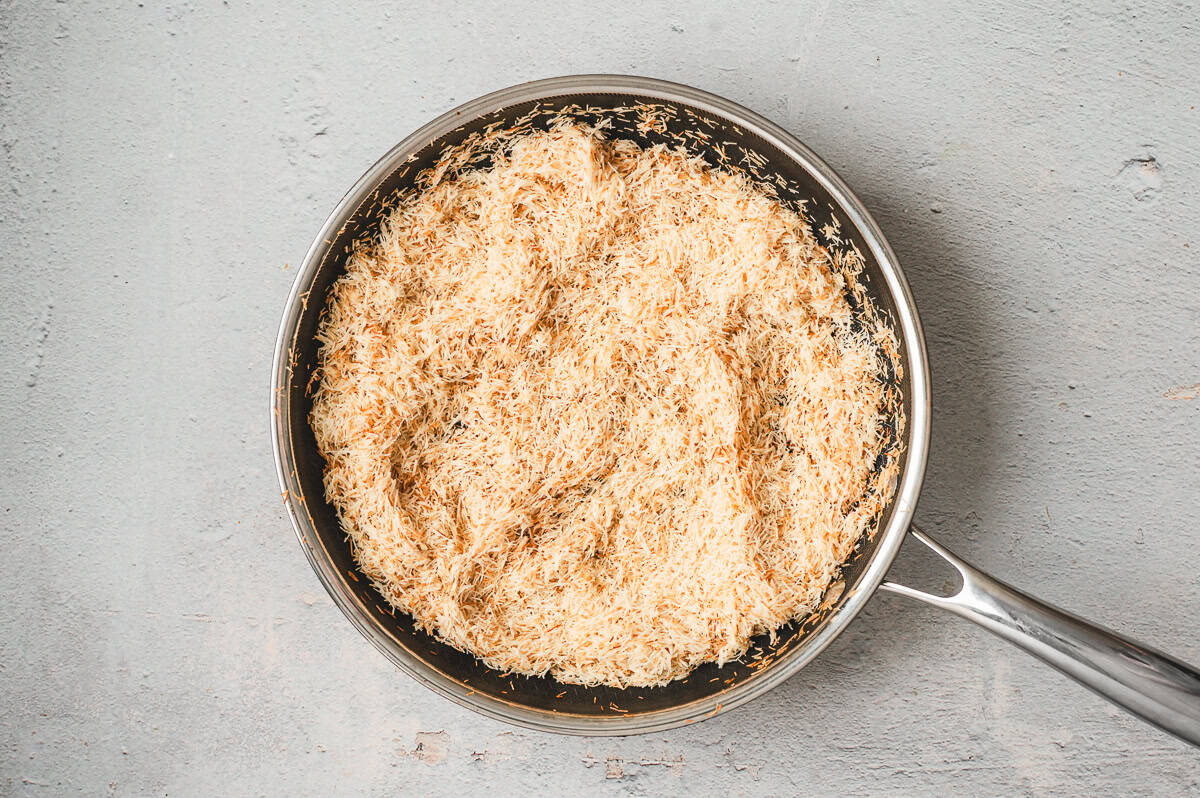 Golden toasted kataifi (shredded phyllo dough) in a stainless steel skillet, showing even browning for truffle filling.
